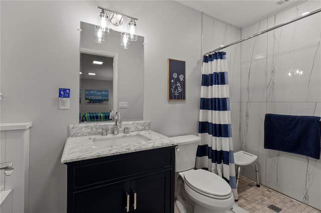 bathroom featuring tile patterned flooring, a shower with curtain, vanity, and toilet