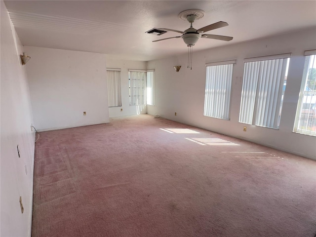 carpeted spare room with ceiling fan