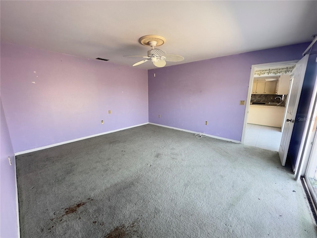 unfurnished bedroom featuring ceiling fan and light colored carpet