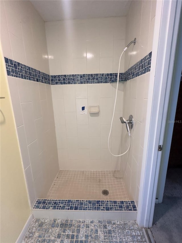 bathroom with a tile shower