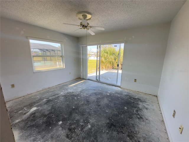 spare room with a textured ceiling and ceiling fan