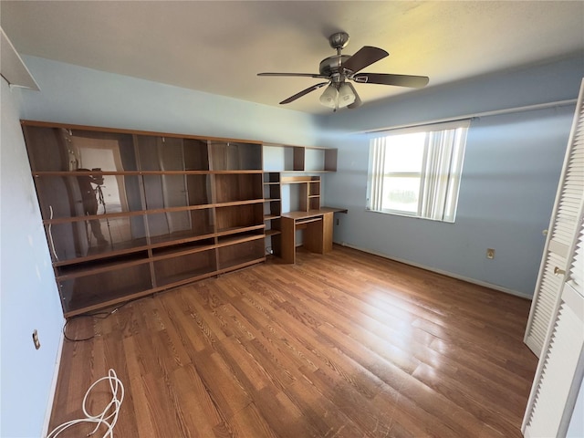 unfurnished bedroom featuring wood-type flooring, a closet, and ceiling fan