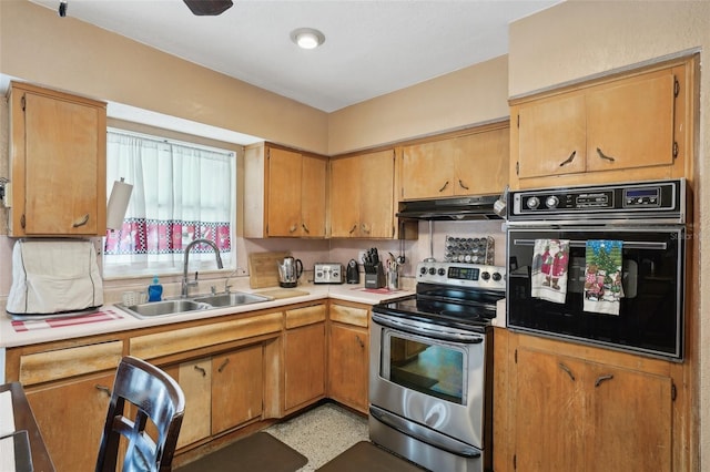 kitchen with oven, stainless steel electric range, and sink