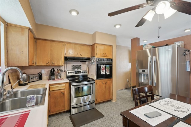 kitchen featuring stainless steel appliances, ceiling fan, and sink