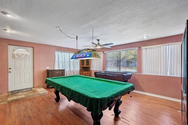 rec room with hardwood / wood-style floors, a textured ceiling, ceiling fan, and billiards