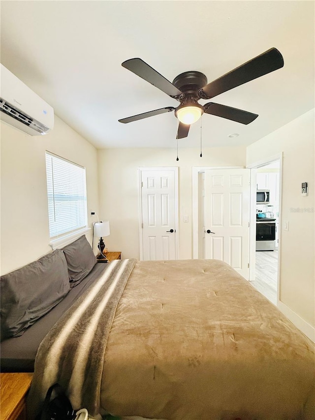 bedroom with a wall unit AC and ceiling fan