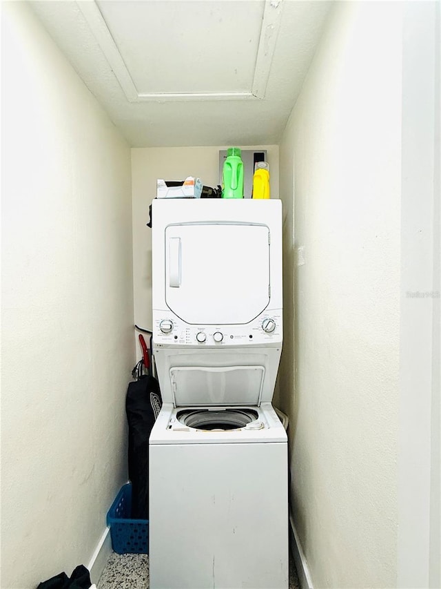 laundry room with stacked washer and clothes dryer