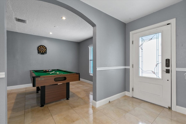 entrance foyer with light tile patterned floors, a textured ceiling, and billiards