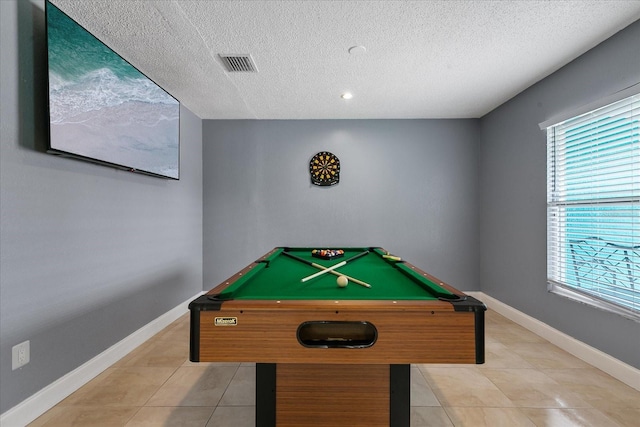 game room featuring a wealth of natural light, light tile patterned flooring, a textured ceiling, and pool table