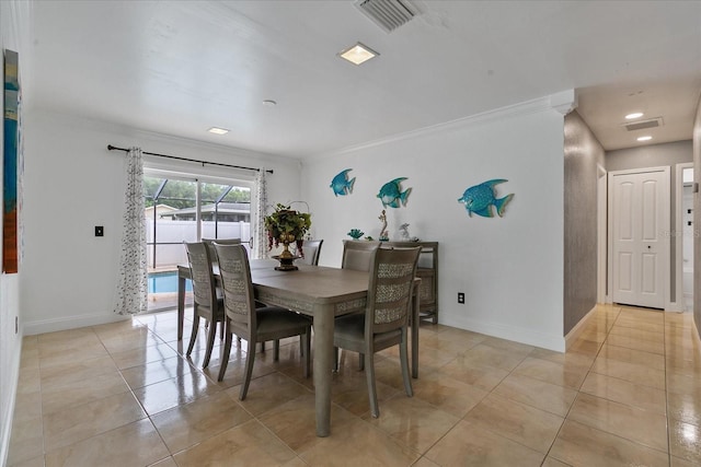 dining room featuring light tile patterned floors and crown molding