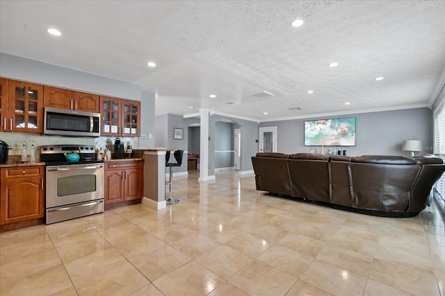 interior space featuring a textured ceiling and crown molding