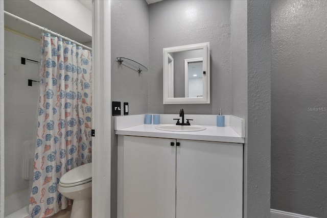 bathroom featuring a shower with curtain, vanity, and toilet