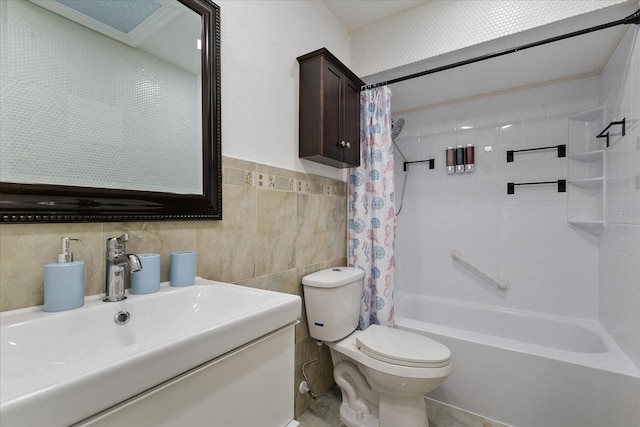 full bathroom with shower / bath combination with curtain, vanity, toilet, and tile walls