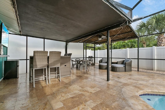 view of patio / terrace featuring ceiling fan and a lanai