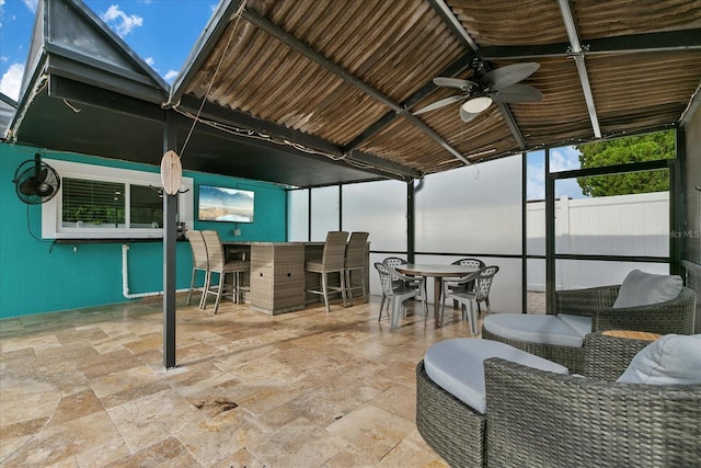 view of patio / terrace with ceiling fan and exterior bar