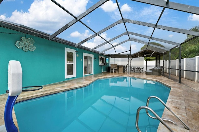 view of swimming pool with a lanai and a patio area