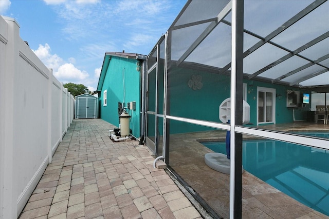 exterior space with glass enclosure and a storage shed