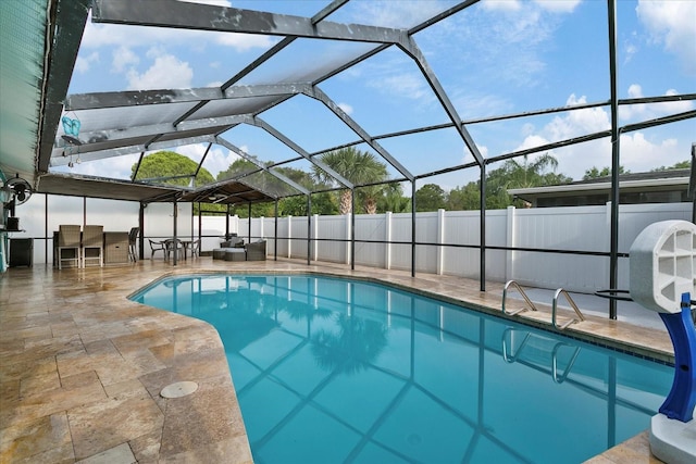 view of swimming pool featuring a patio area and glass enclosure