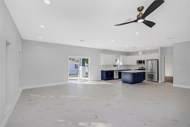 unfurnished living room with ceiling fan