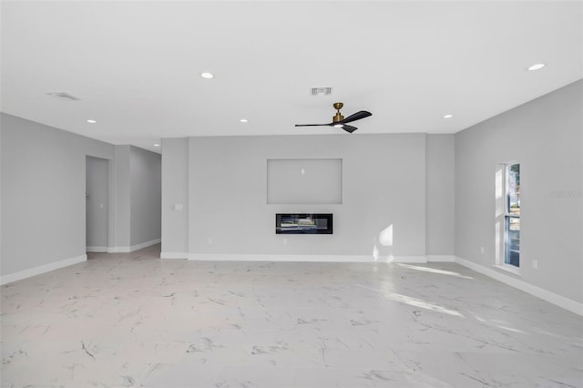 unfurnished living room with ceiling fan