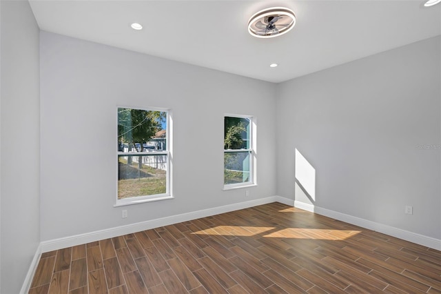 unfurnished room with dark wood-type flooring