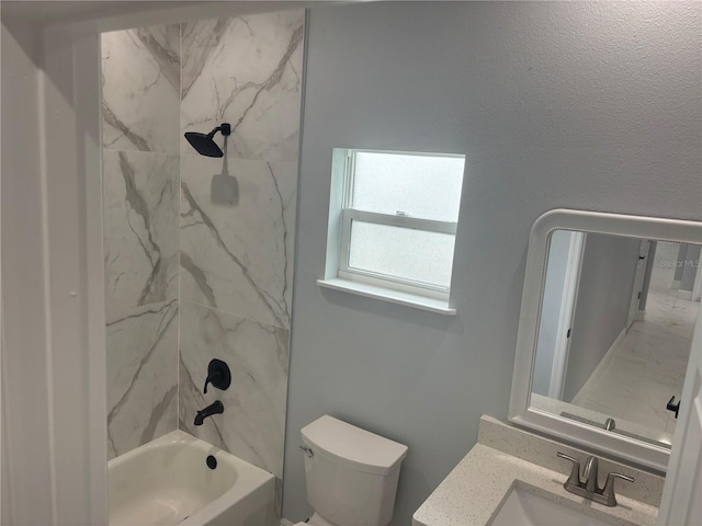 full bathroom featuring vanity, toilet, and tiled shower / bath