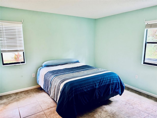 bedroom with light tile patterned floors