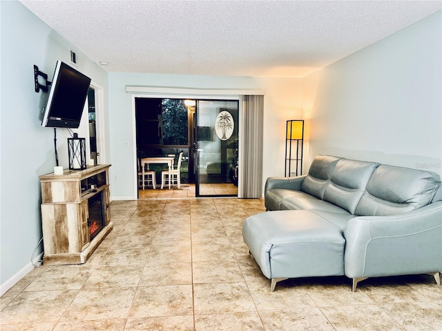 tiled living room featuring a textured ceiling