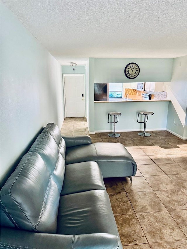 tiled living room with a textured ceiling