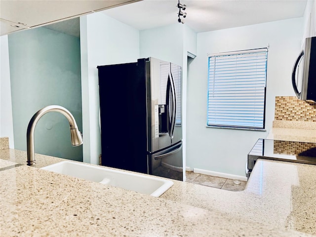 kitchen with sink, light tile patterned flooring, and appliances with stainless steel finishes