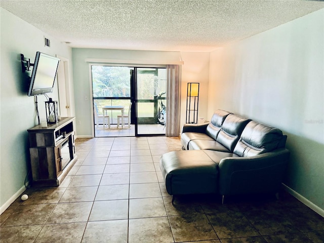 living room featuring tile patterned flooring and a textured ceiling