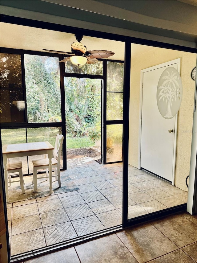 doorway to outside with ceiling fan and a healthy amount of sunlight