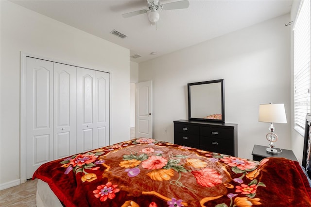 carpeted bedroom featuring ceiling fan and a closet