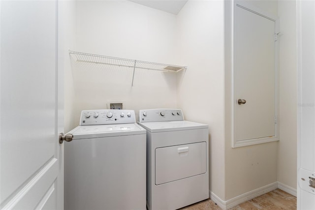 washroom with washing machine and clothes dryer