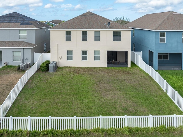 back of property featuring a yard and cooling unit