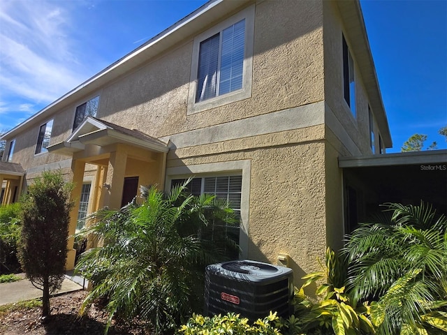 view of side of home featuring central AC