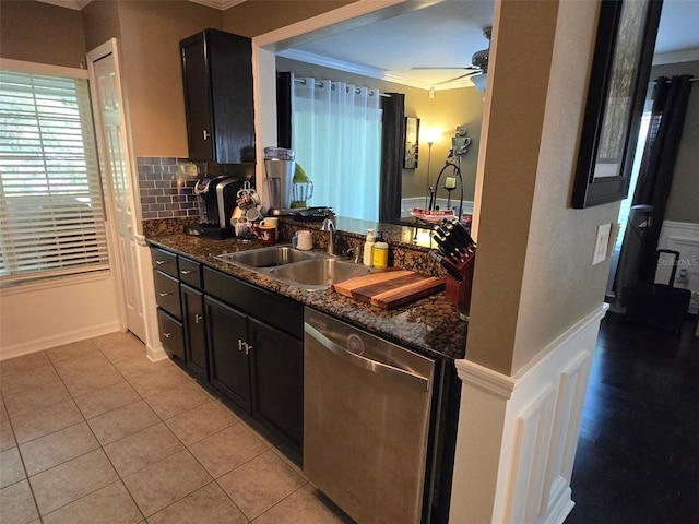 kitchen featuring sink, ornamental molding, decorative backsplash, stainless steel dishwasher, and dark stone counters