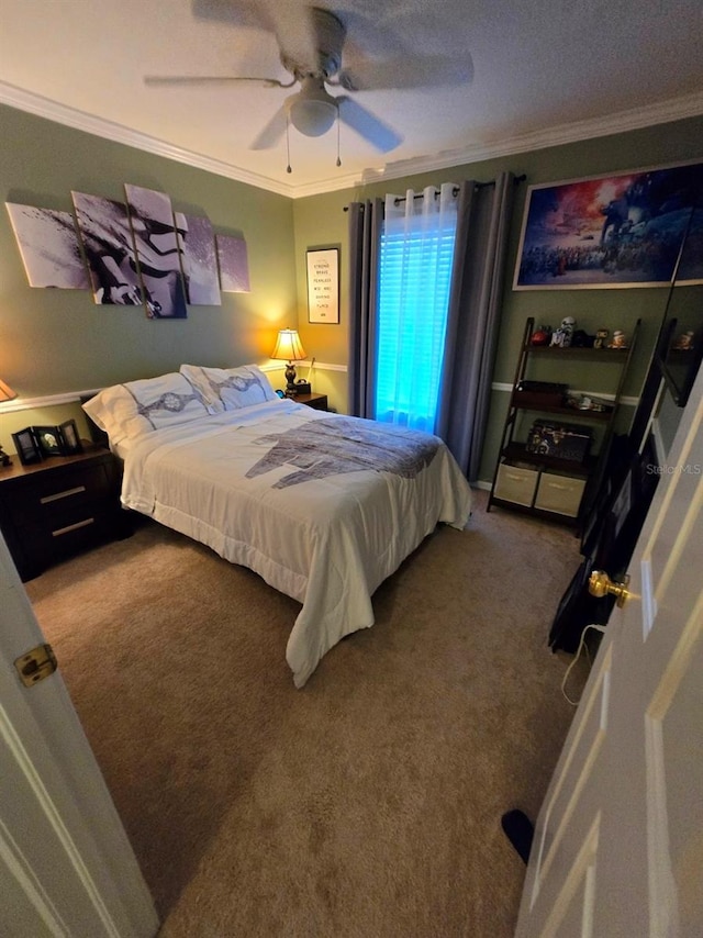 bedroom featuring crown molding, carpet flooring, and ceiling fan