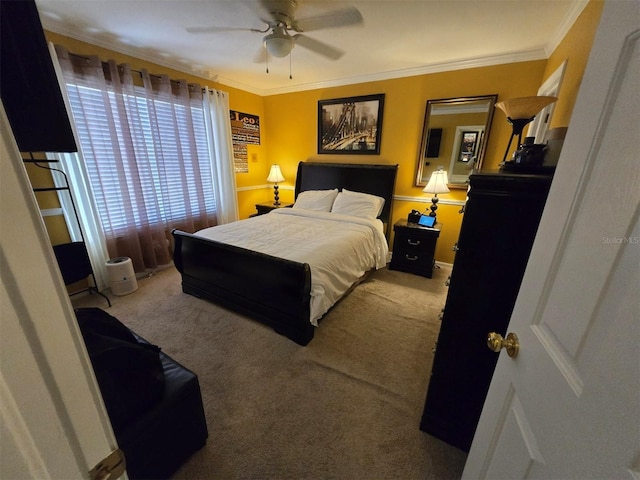 bedroom with crown molding, ceiling fan, and carpet flooring