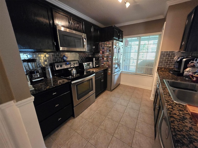 kitchen with light tile patterned floors, crown molding, sink, appliances with stainless steel finishes, and backsplash