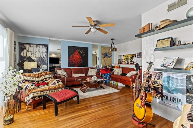 living room featuring wood-type flooring and ceiling fan