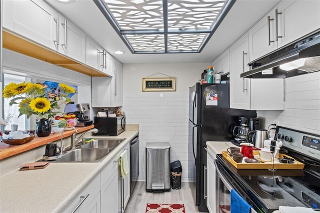 kitchen featuring sink, electric range, white cabinets, and light wood-type flooring