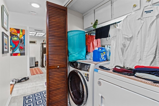 clothes washing area with washer and clothes dryer