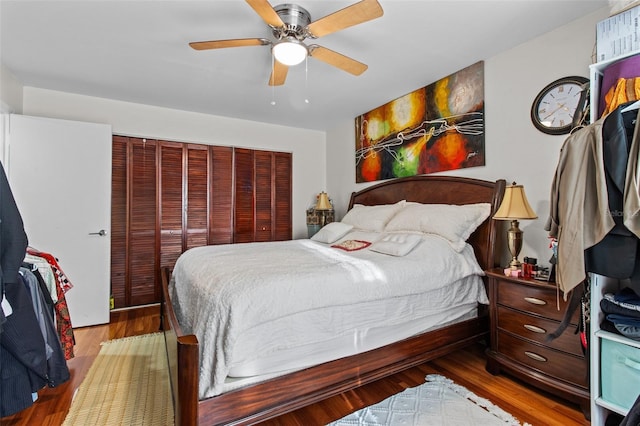 bedroom with wood-type flooring, ceiling fan, and a closet