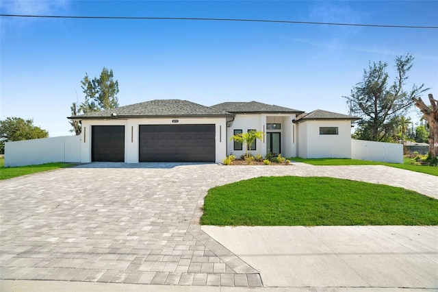 prairie-style home with a front yard and a garage