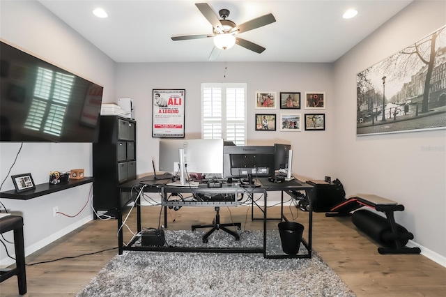 home office featuring hardwood / wood-style floors and ceiling fan