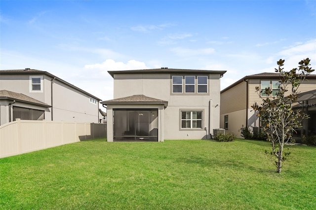 back of property featuring a yard, central AC unit, and a sunroom