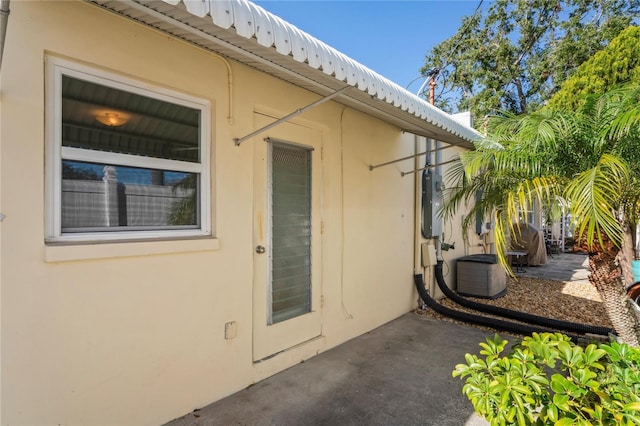 entrance to property with a patio area and central AC