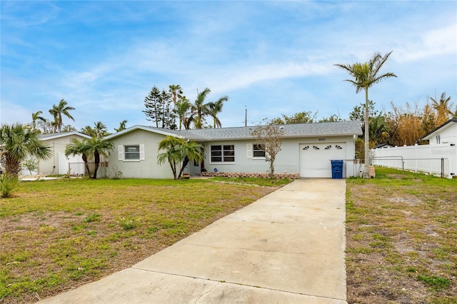 view of front of house featuring a garage and a front lawn