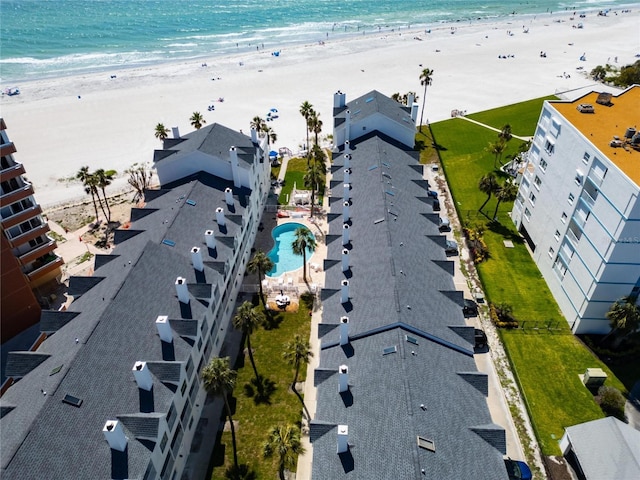 drone / aerial view featuring a water view and a view of the beach